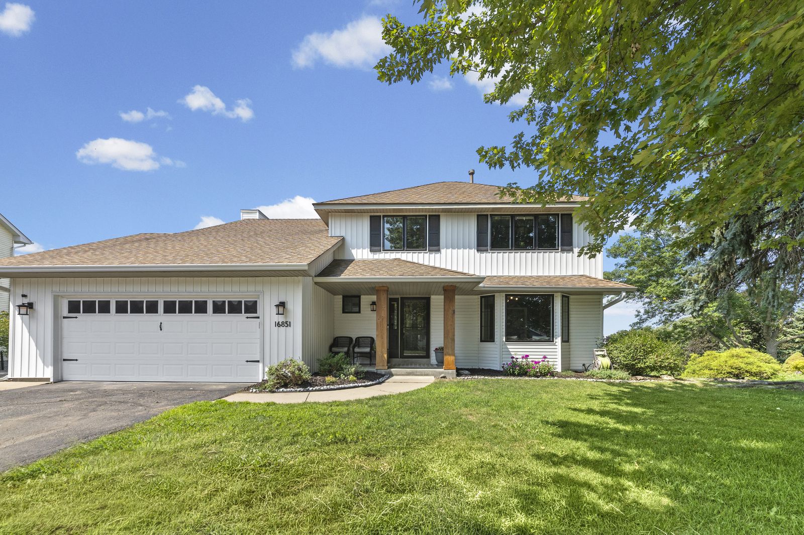 Front exterior of two-story house with attached garage and driveway