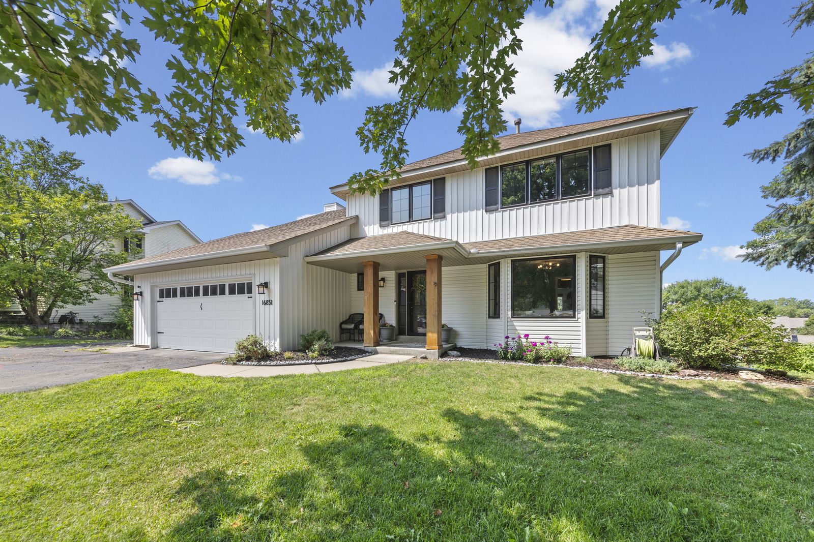 Front exterior of house in daylight with driveway