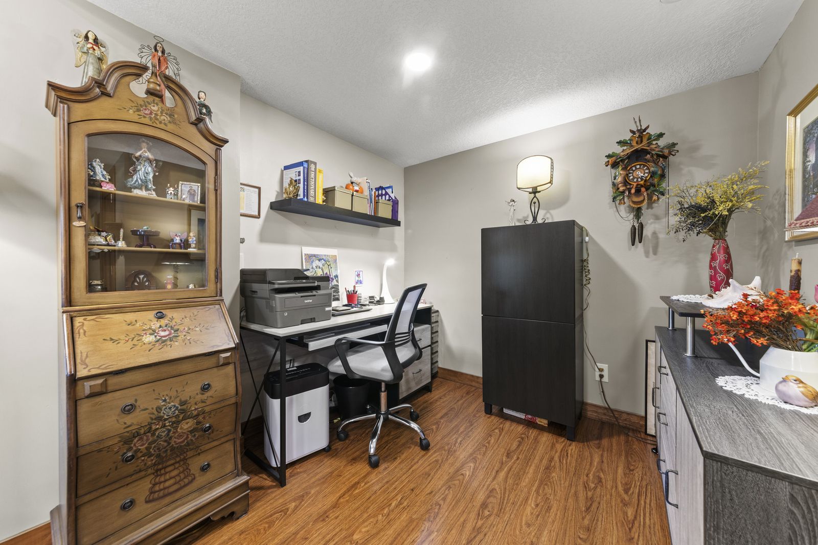 Home office with dark wood furniture and desk