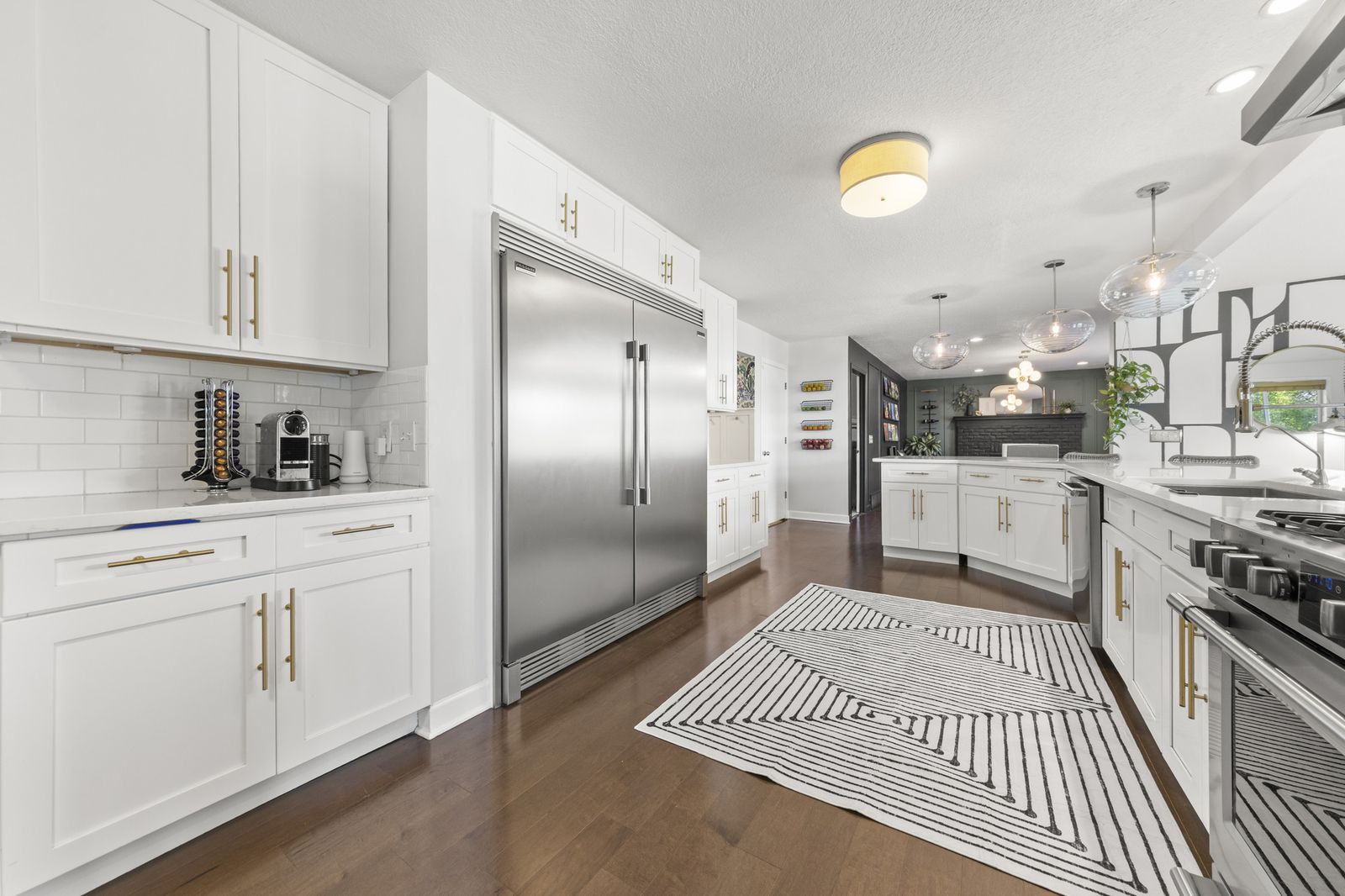 Kitchen with stainless appliances and striped rug