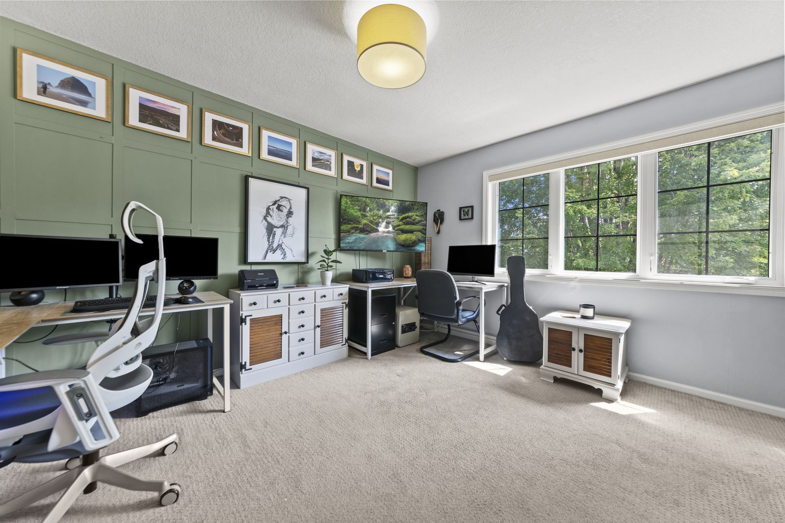 Upstairs home office with green walls and desks