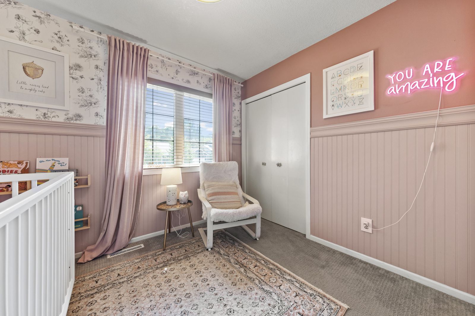 Nursery with crib, chair, and floral wallpaper, alternate view