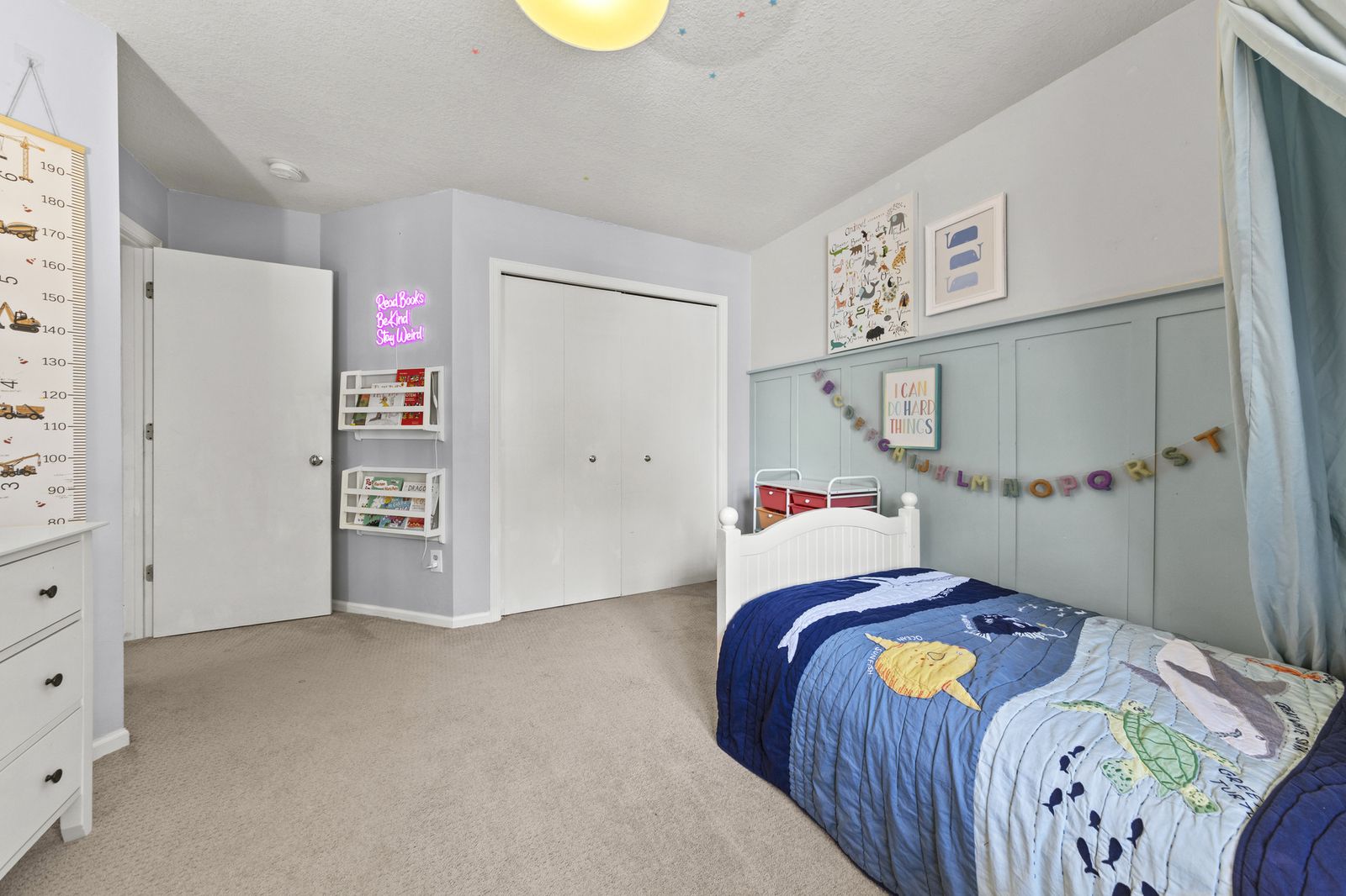Bedroom with neon sign and twin bed
