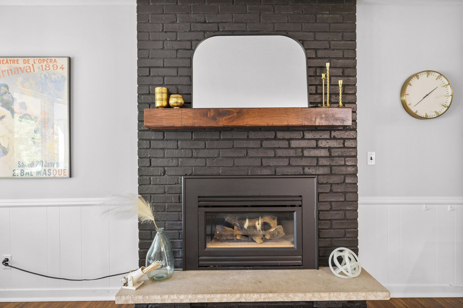 Close-up of black brick fireplace with mantel