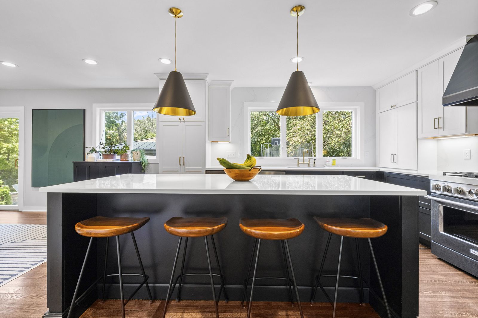 Kitchen island with bar stools and pendant lights