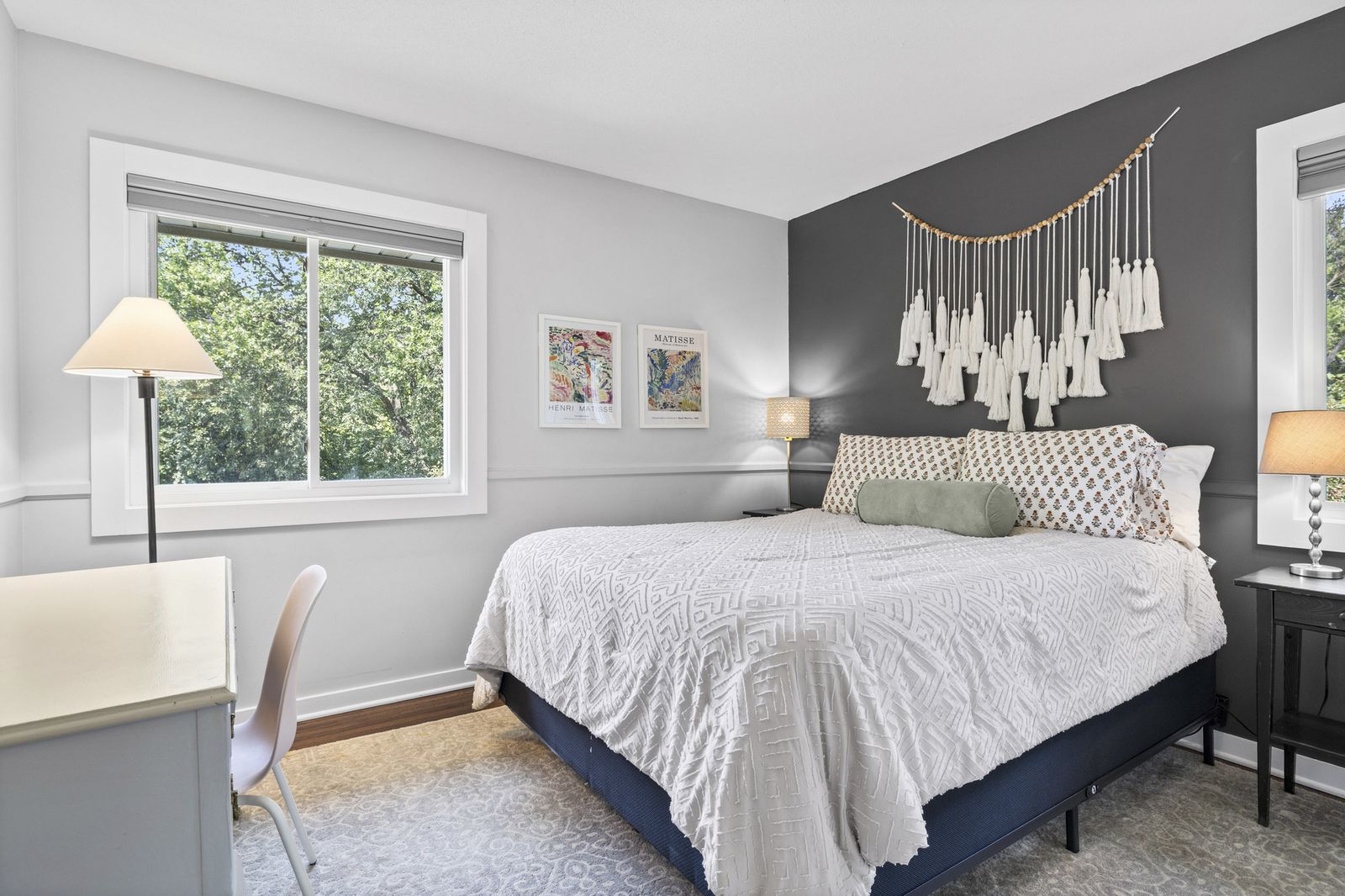 Bedroom with dark accent wall and desk
