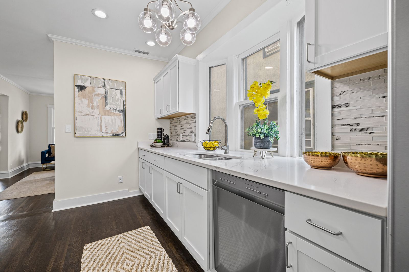 Kitchen with long white countertop and dishwasher