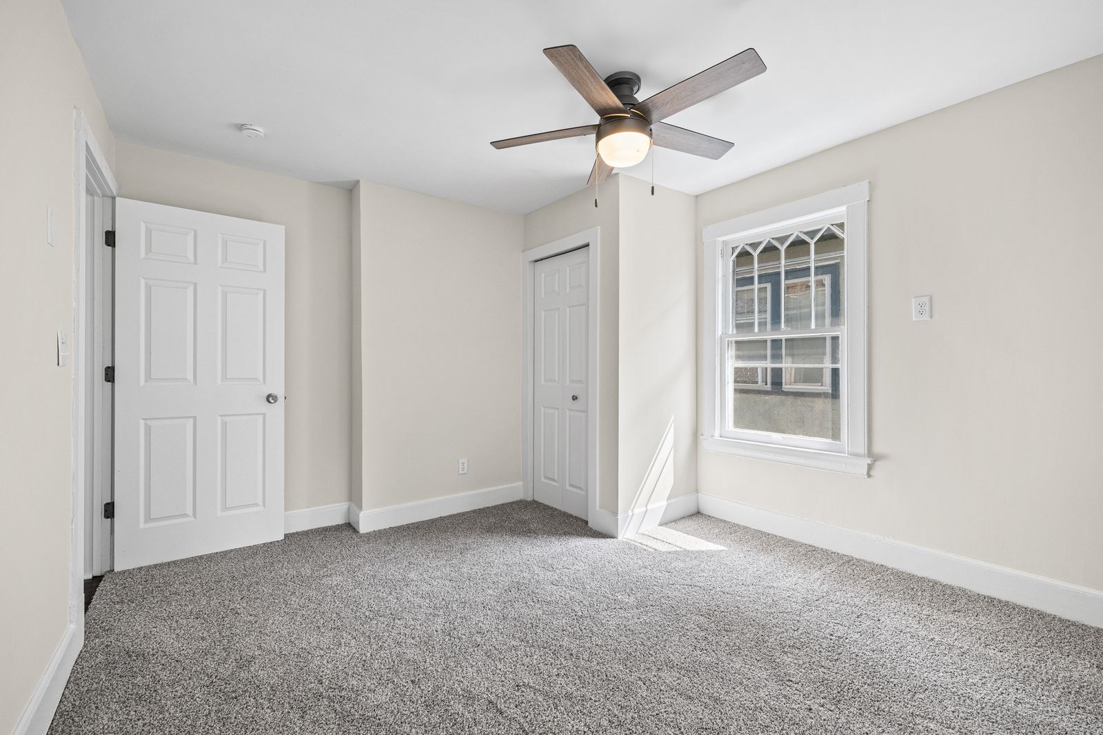Upstairs bedroom with ceiling fan and closet