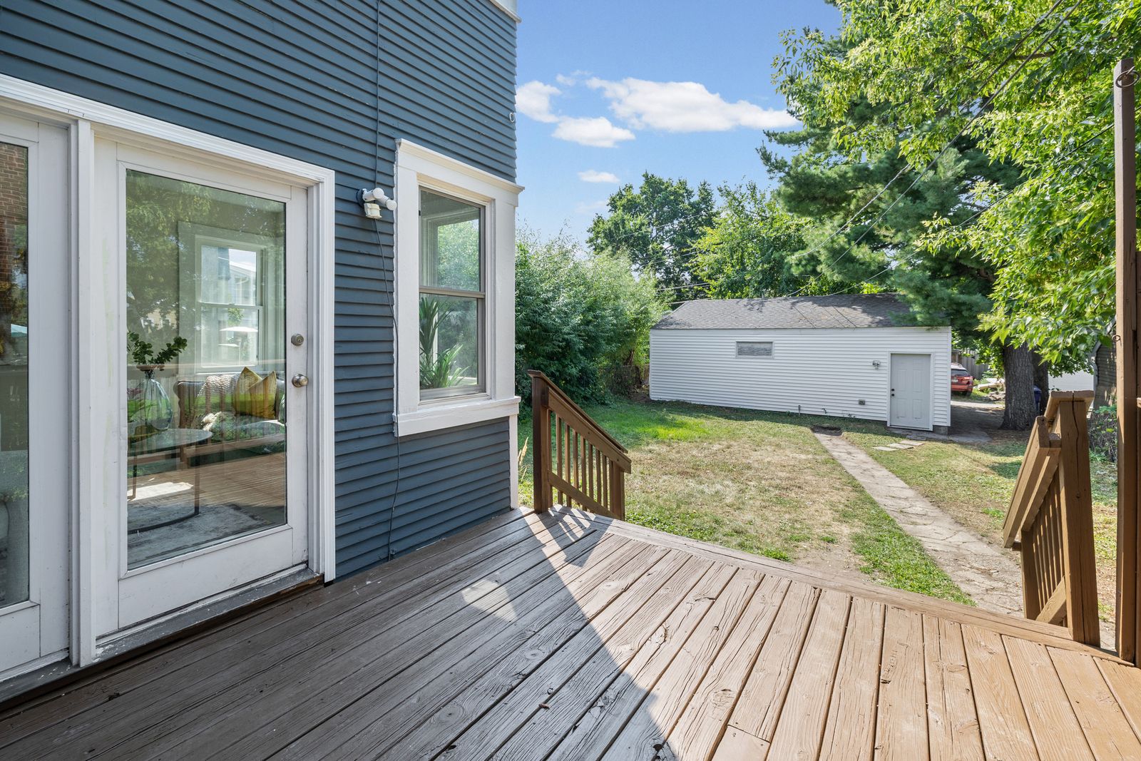 Rear deck with view of backyard and detached garage